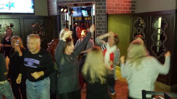 I'm in there somewhere... -- Witnessing a rhythmic ceremonial ritual from the Waukee natives at Saints Pub & Patio in November 2014.