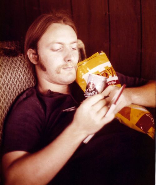 Writing lyrics in a hotel room while clutching my snacks!
