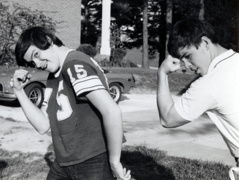 Rick Sheppard and George Palmer posing in front of Rick's red MG-B sports car, June 1971