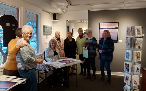 Signing of posters by winning artist Pam Duncan