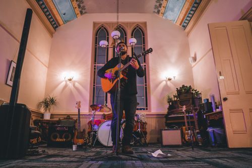 Jordan Sings the singer-songwriter Playing acoustic guitar and singing for live show