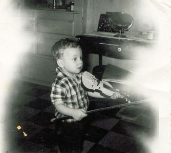 Little David, age 2,toys with a violin. His grandfather, Martin Iglar, was a violinist who encouraged Dave to play music.