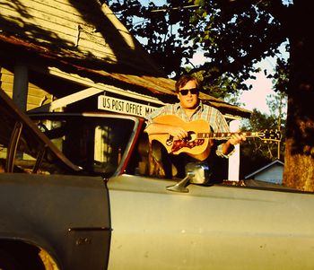 Just Livin' In These Hard Times...in front of the Manassas, GA post office in Kermit's Silver Bullet custom convertable...Sammy Johnson used a cutting torch to customisze the roof. That is my 1970 Gibson J200 guitar circa 1993.