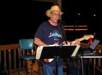 Friday night 9-7-2012 on the deck at The Pond House in Metter, GA. This photo was not intended as a political statement because of the empty chair onstage behind me. :o) It just turned out that way.....so here is to Clint.