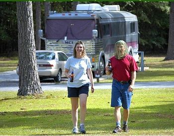 Good friend and awesome harmonica/flute player Scott Welcker and wife Joy with Bob's tour bus in the background at Magnolia State Park in south Georgia during gnat season. Nice hat Scott...