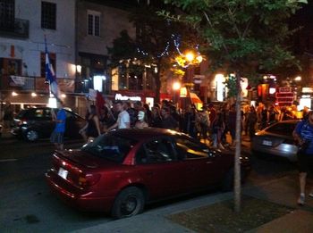 We're in Montreal! As we indulged in pizza on a patio, a group of student protestors came down the street, singing, playing instruments, waving flags, & wearing masks.