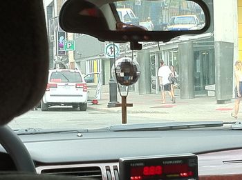 A cross and disco ball hanging from our cabbie's mirror. Don't know what it means, but interesting dichotomy.