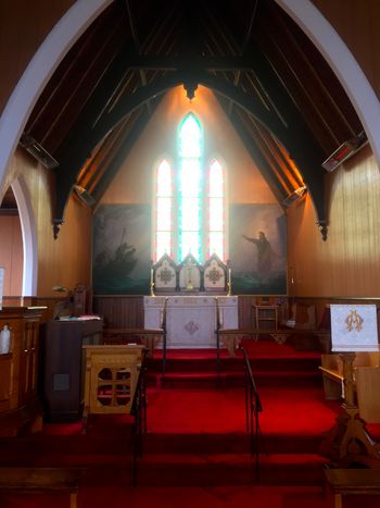 The interior of St. John's is known for something very special: two murals painted directly onto the church walls by artist William E. deGarthe.