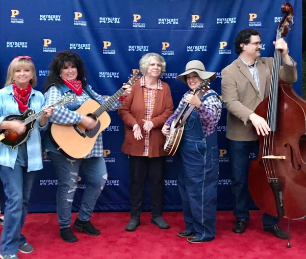Local bluegrass band Berachah Valley, which includes retired Carlisle teacher Cathy Baker, had the opportunity to be featured in an upcoming movie called Mayberry Man, a film that pays homage to The Andy Griffith Show.
The movie centers on a man who is caught speeding and is sentenced to attend a festival celebrating The Andy Griffith Show. The movie was written and directed by Stark Howell. His father, Hoke Howell, was in two episodes of The Andy Griffith Show and also appeared in other shows such as Bonanza. According to the website for Mayberry Man, Stark first attended Mayberry Days because he was representing his father there.
Baker said it was an opportunity that sort of fell in their lap. She said a lady from North Carolina called the band. Berachah Valley has played at Mayberry Days in Mt. Airy, North Carolina for about four years. Mt. Airy was Griffith's hometown. The lady had mentioned Berachah Valley to the producer, who wanted the band to contact him.
Baker said Cort Howell, who was the producer was very nice and personable. He funded the movie through crowdfunding. Baker said she appreciated that they were trying to include fans. "That's a dream come true for an Andy Griffith fan," she said. After discussing it as a band, they decided to support the project.
"I thought it was amazing that people like us could be included in a fun family film," Baker said. The band didn't do any acting in the film, but they were only interested in playing music in the movie. Baker said she is not sure how much they will be featured in the movie. She said they were originally only supposed to film in North Carolina, but they were later asked to travel to Indiana to film as well.
"It could just be five seconds, but for us that's A-OK," Baker said. "We supported something we believe in. We had a total blast being there and it was a great, great experience for us, so we are more than happy with however it turns out."
For one of the scenes, Baker said they were playing a song from The Andy Griffith Show on the courthouse steps while there was an audience in front.