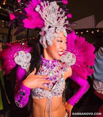With a costume that shines with every move this samba dancer is wearing a hot pink outfit covered with shining sequins
