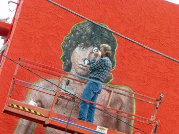"Yep, That's Him" Artist Rip Cronk refreshes his famous mural of Jim Morrison, located on a beachside building at Venice Beach in the summer of 2012 while using Morrison’s famous “Lion Shoot” photo for reference. Venice Beach was the location of the re-meeting of Morrison and Manzarek in 1965 where “The Doors” were born.