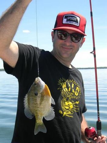 ..I've bought just about everything you put out - 45s, 10"s, CDs, DVDs, t-shirts. I have attached a picture of me sporting one of my Wild t-shirts while fishing in Lake Miltona, MN. My family and I listened to Wild Records all the way when traveling in our car to the lake (8 hours one way). Keep putting out the great music-Gary