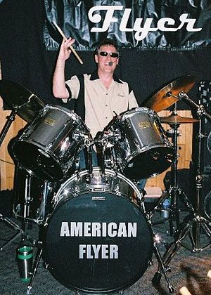 Dave Alexander - Drums and Vocals - Dave has been playing drums since he banged on his Mom's pots and pans when he was 5. He got his first drum set when he was 10 and started a garage band called "Boot Hill Express," playing hard rock and 60s pop for the neighborhood kids. He played casually in high school and college, sitting in with cover bands as a session player. He joined American Flyer in 2005. Besides a growling voice that's been compared to Rod Stewart, he lays down the snappy grooves that help create the band's crisp, tight sound.