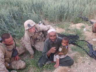 Interpreter far left, young patient and father, Afghanistan, 2010