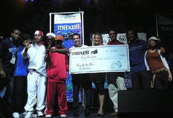 Amy accepting a $20K check from Executive Director Brian Rothschild, Peter Brinkman VP Maxell Corporation and the Black Eyed Peas on July 17 2003