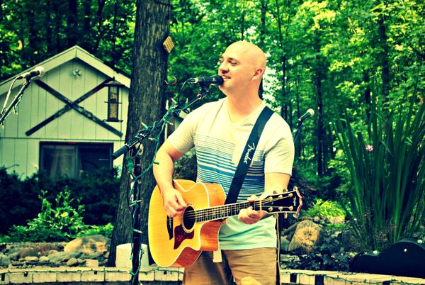 Johnny performing at a house concert in 2013