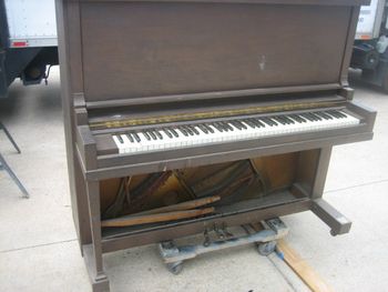 1915 Baldwin Midsized upright shown before stripping, trashed finish with gold antiquing someone applied, making it worse, trashed trap work ( pedals) missing a leg and lower door.
