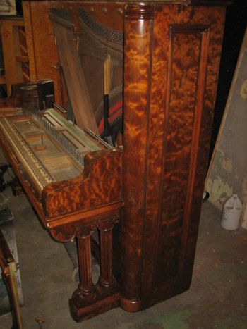Side view after Sanding and Sanding sealer, the sealer closes the pores of the wood so you can put the clear coats on. pictured with no stain. The columns and legs are solid walnut as are all of the hardwood parts on this piano. This is rare. most of the time you have to stain match the legs as they are made of Sycamore or Poplar