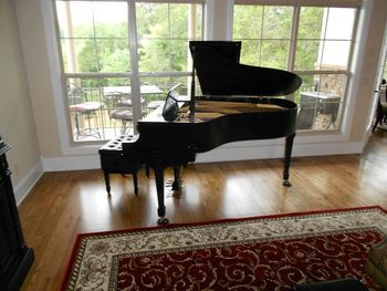 5.6 ft Story & Clark with it's new satin ebony finish, new nickel accents and casters, looks great in it's new home