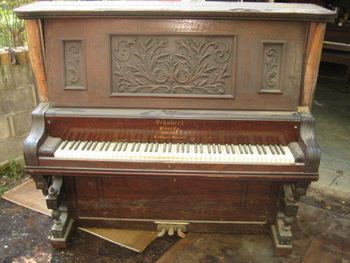 1887 Schubert with a trashed finish,Veneer is some type of open grain 1/4 sawn burl. Area wood experts dont know what it is