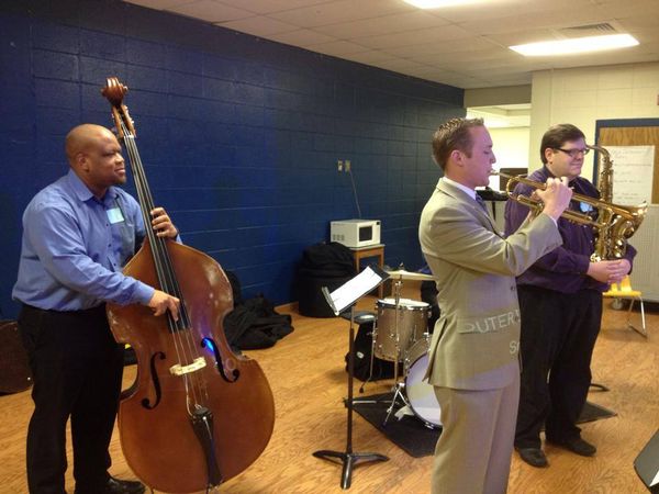 GJC Music Director and bassist Shannon Hoover plays with Band Director Jake Mitchell at Northwest Middle, as Director of Jazz at Furman Universtiy and saxophonist, Dr. Matt Olson, listens.
