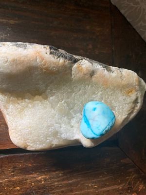 Photo of the white stone given to Mitch Bensel from God.A small blue stone has a 