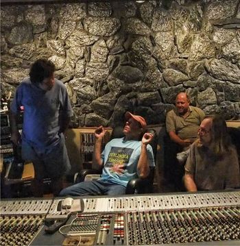 In the booth at Audio Dallas with owner and engineer, Paul Osborn (standing), Milo Deering, producer (sitting at the mixing board), and Barry Johnson, Executive Producer seated by the wall.