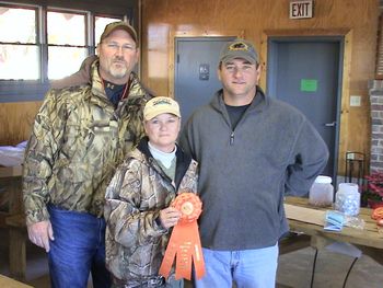 Angie receives "Thorne's" AKC Master Hunter title ribbon from AKC Master Hunter judge Davis Byrd. Chris Adams was "Thorne's" handler.