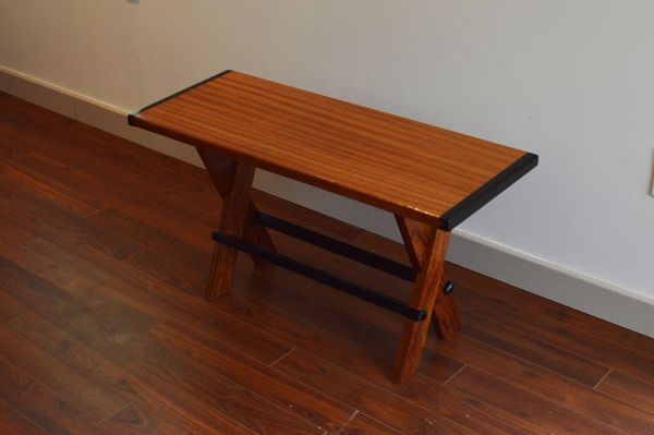 Mahogany top with Ebony breadboard edges. Bubinga and Ebony base. 34" x 14" x 19".