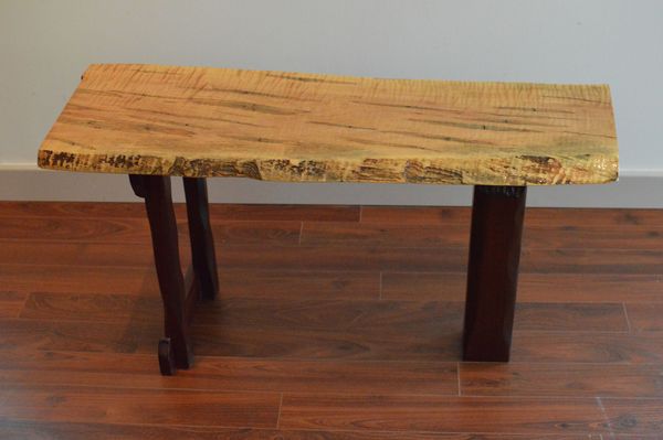 Quilted and Spalted Maple top with a natural edge. Carved Ipe base. 36" X 15" X 19"