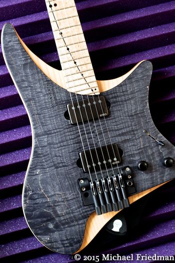 (02/10/15) This is a Strandberg Masvidalien, I love this guitar. It has a very cool body design. The back is Mahogany, the middle is Alder and the top is Flamed Maple. It has a Birdseye Maple neck and fretboard with stainless steel frets. The neck has the EndurNeck profile. It also has Ola Strandberg's Trem which I added a Tremol-No to. The pickups are EMG 57/66. As with the 7 string Boden I have, This is truly an amazing instrument.