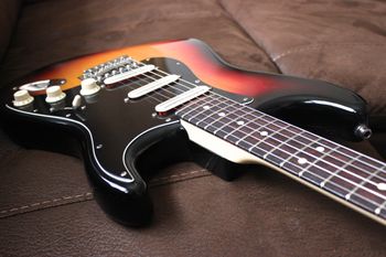 (11/12/13) This is one of my all time favorite Strats. It is a Fender Highway 1 Stratocaster that I have modded over time. It started with a satin nitro finish
that from playing and sweating on became shiny. It has locking tuners and a black pickguard. The pickups were swapped out for a set of Joe Bardens. They have all the twang and Strat spank you could want without any noise or hum. The body is Alder with a Maple neck and Rosewood fretboard. The Frets are stainless steel jumbos. I love this guitar and will never part with it. It is everything that a Stratocaster should be.