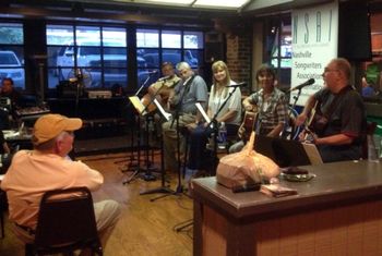 Coordinator Charlie Crow looks on as Joe Sorrels performs at Khalil's; also pictured Judy Olsen, Mel Blaylock and Steve Smith