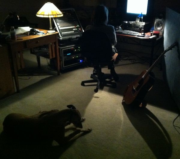 Jennifer listening to some new tracks with our greyhound, Crazy Boy Bob.