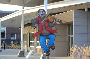 Fiddler statue out front on Morinville Theater
