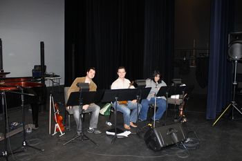 The string section at rehearsal before showtime.
