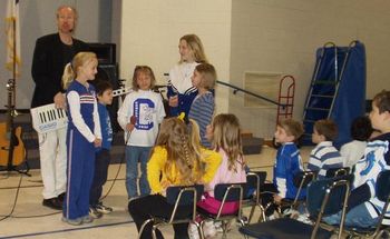 Getting help from the young musicians in a school assembly
