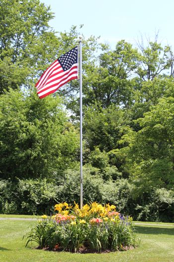 Flagpole with daylilies.
