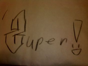 By young 5 year old fan at a show drawing on a restaurant table cloth, 2012.
