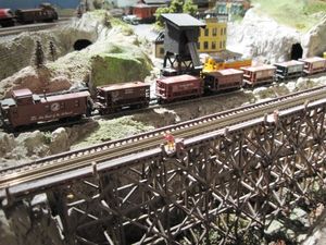 At the AdamEric'a Mine, an ore train is being  loaded as the mine switcher brings out a another filled ore car.