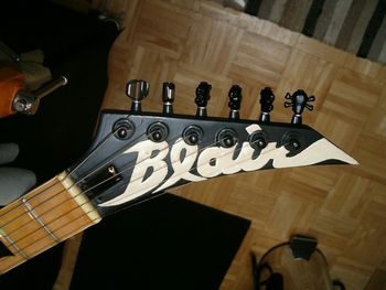 Modified 6 in-line headstock with hand-painted logo, skull & crossbones tuner buttons
