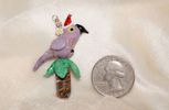 TJEG-0002 Small Purple Parrot in a Palm Tree