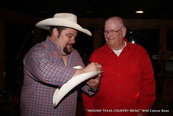 Eric wayne signing an autograph.
