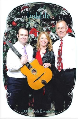 I played the harp-not the guitar-at the Columbia Tower Club in Seattle for a group of 300 event professionals. Here I am with the other 75th Floor "band"--the Chris Bayman Guitar Duo. Dec 2011. Photo by 1000 Words
