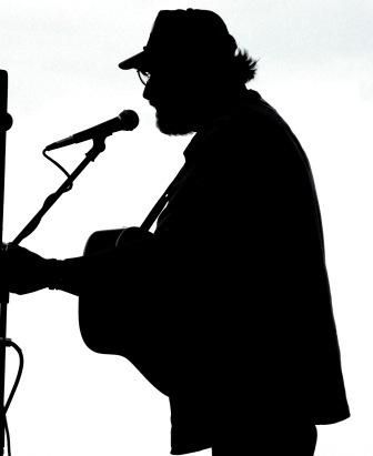 Jim Page in silhouette at Jim Hinde’s memorial, Pike Street Market 2008.
