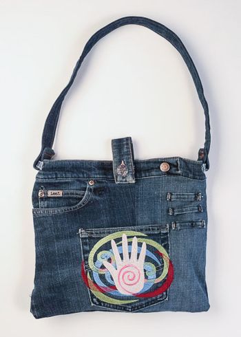 Denim tablet bag with Five Elements - Spirit embroidered on the pocket.
