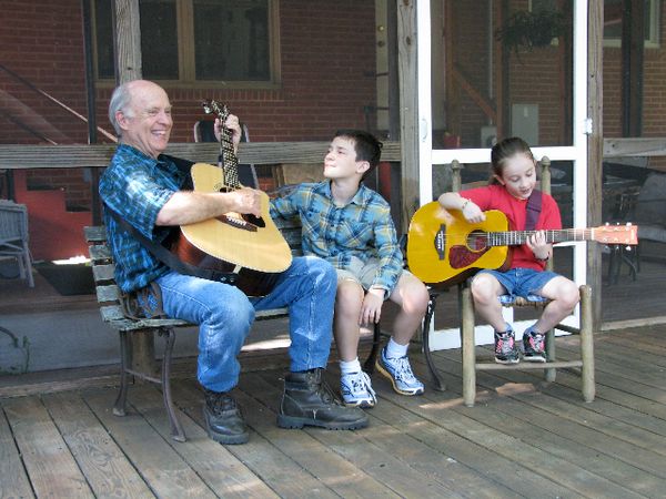 Singing "front porch gospel" songs on the back porch with grandchildren, Grayson and Cara.