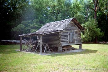 Smoke house with an overhang for farming tools.
