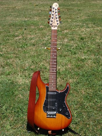 My go-to electric 12-string, a Yamaha Pacifica, #OX16109. Half the tuning buttons have been swapped from chrome to amber so I can identify the octave strings by touch. The Strat-style pups are a little too clangorous for my 12-string taste, so someday I'll swap them out for P-90s or mini-humbuckers.
