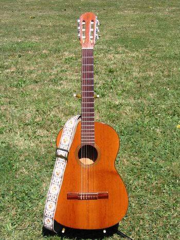 I bought this hand-made nylon-string guitar at a yard sale for $20 because it had a surprisingly strong bass response. Then I refretted it, made a new nut and saddle, put on new tuners, and repaired the center crack in the face. And now it works real good!

